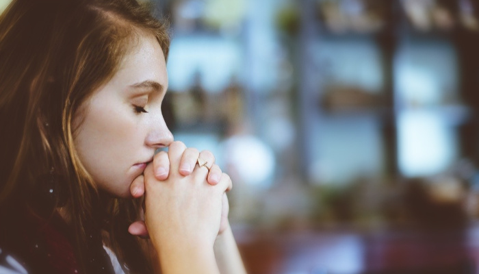 A woman prays.