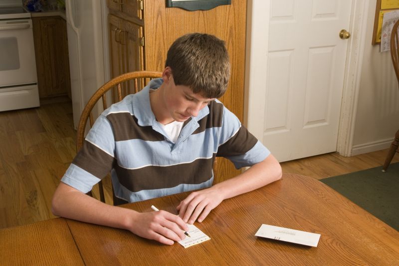 A young man fills out a tithing slip. Obedience to the commandments of God qualifies us to receive His blessings.